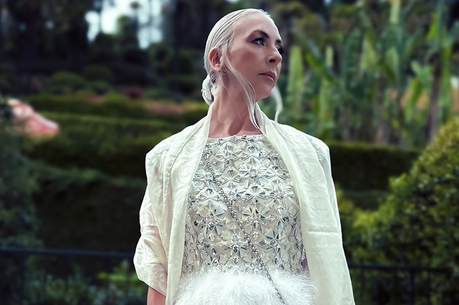 Chanel Princess - Curator of world's largest private Chanel collection wearing exclusive haute couture Chanel ensemble with intricate embellishments and dramatic feather details, embodying luxury fashion expertise and museum-grade collecting